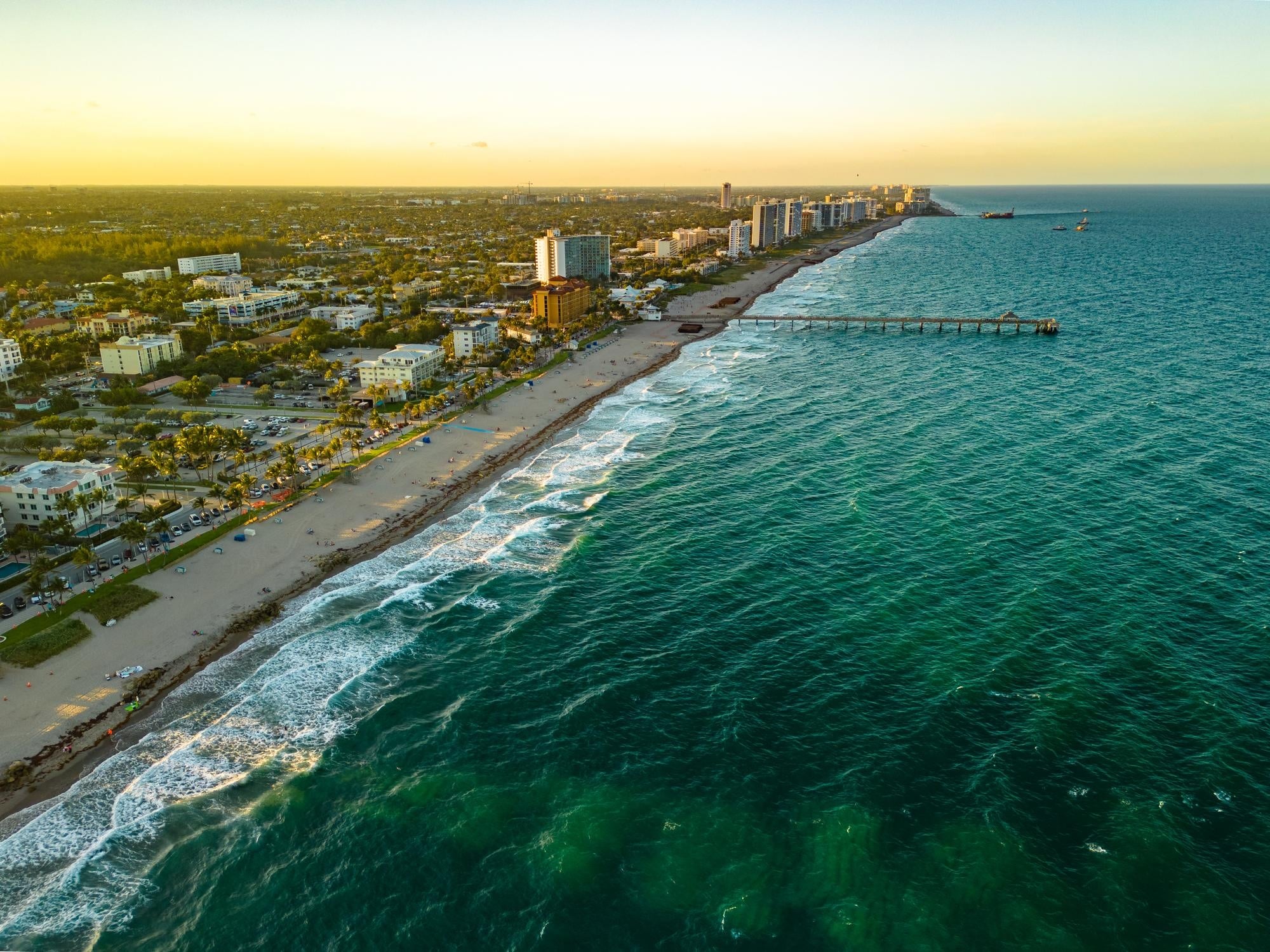 A beach with buildings and water.